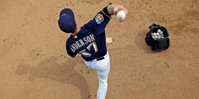 Milwaukee Brewers' Chase Anderson warms up before a inning of a spring training baseball game against the Chicago Cubs Thursday, March 3, 2016, in Phoenix. (AP Photo/Morry Gash)