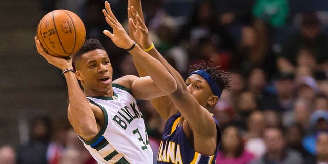 Apr 13, 2016; Milwaukee, WI, USA; Milwaukee Bucks forward Giannis Antetokounmpo (34) passes the ball as Indiana Pacers forward Myles Turner (33) defends during the first quarter at BMO Harris Bradley Center. Mandatory Credit: Jeff Hanisch-USA TODAY Sports