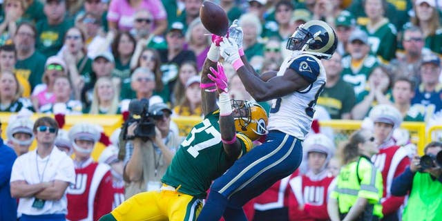 Oct 11, 2015; Green Bay, WI, USA; Green Bay Packers cornerback Sam Shields (37) breaks up the pass intended for St. Louis Rams wide receiver Brian Quick (83) during the second quarter at Lambeau Field. Mandatory Credit: Jeff Hanisch-USA TODAY Sports