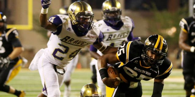 Southern Miss Golden Eagles running back Ito Smith runs with the ball as Alcorn State Braves defensive backs Warren Gatewood and Devon Francois close in.
