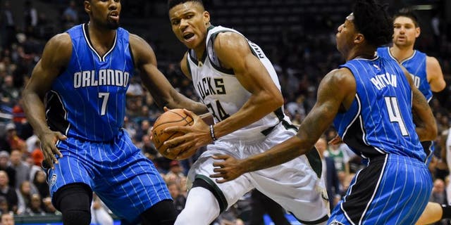 Nov 21, 2016; Milwaukee, WI, USA; Milwaukee Bucks forward Giannis Antetokounmpo (34) drives for the basket against Orlando Magic forward Serge Ibaka (7) and guard Elfrid Payton (4) in the fourth quarter at BMO Harris Bradley Center. Mandatory Credit: Benny Sieu-USA TODAY Sports