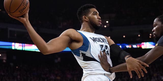 Nov 26, 2016; Oakland, CA, USA; Minnesota Timberwolves center Karl-Anthony Towns (32) controls the ball against Golden State Warriors forward Kevin Durant (35) during the first quarter at Oracle Arena. Mandatory Credit: Kelley L Cox-USA TODAY Sports