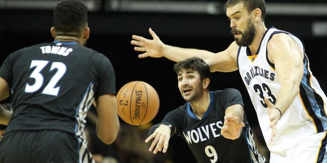Nov 19, 2016; Memphis, TN, USA; Minnesota Timberwolves guard Ricky Rubio (9) passes to center Karl-Anthony Towns (32) as Memphis Grizzlies center Marc Gasol (33) defends at FedExForum. Memphis defeated Minnesota 93-71. Mandatory Credit: Nelson Chenault-USA TODAY Sports