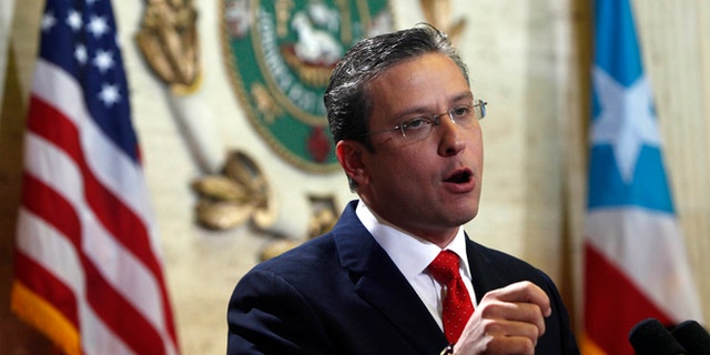 FILE - In this April 25, 2013 file photo, Puerto Rico Gov. Alejandro Garcia Padilla speaks during a state of the commonwealth address at the Capitol building in San Juan, Puerto Rico. A new plan backed by Garcia aims to boost revenue and tackle the U.S. territorys spiraling public debt by creating a 16 percent value-added tax, or VAT. If approved, manufacturers would pay the tax on raw materials and include it in the price of the product sold to retailers, who then would pass it on to consumers. (AP Photo/Ricardo Arduengo, File)