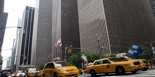 NEW YORK, NY - JUNE 18: Taxies drive down Sixth Avenue, also known as "Avenue of the Americas" on June 18, 2013 in New York City. The prices for office space along sixth avenue, typically famous for being some of the most expensive real estate in New York, have been falling recently. (Photo by Andrew Burton/Getty Images)