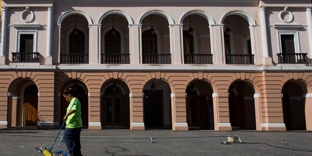 A worker sweeps up litter in San Juan, Puerto Rico.