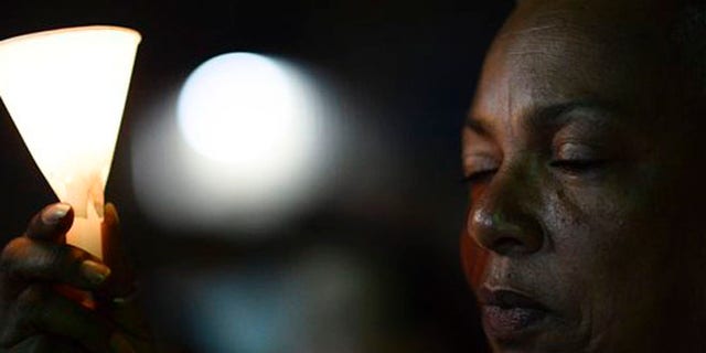 Residents carry out a vigil to honor the memory of the Puerto Ricans that died in the mass shooting at a nightclub in Orlando, Fla., at the Hato Rey LGBTT Community Center in San Juan, Puerto Rico, Tuesday, June 14, 2016. Dozens of people died at the 'Pulse' gay nightclub in Orlando, making it the deadliest mass shooting in modern U.S. history. (AP Photo/Carlos Giusti)