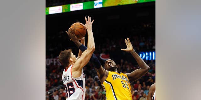Atlanta Hawks guard Kyle Korver, left, and Indiana Pacers center Roy Hibbert (55) battle for the rebound in the first half of Game 4 of an NBA basketball first-round playoff series, Saturday, April 26, 2014, in Atlanta. (AP Photo/John Bazemore)