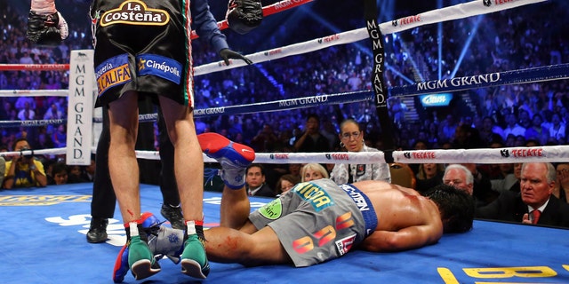 Manny Pacquiao lays face down on the mat after being knocked out in the sixth round by Juan Manuel Marquez during their welterweight bout at the MGM Grand Garden Arena on December 8, 2012 in Las Vegas, Nevada.  (Photo by Al Bello/Getty Images)