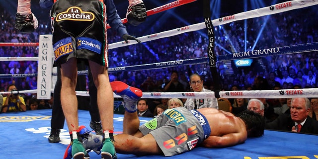 Manny Pacquiao lays face down on the mat after being knocked out in the sixth round by Juan Manuel Marquez during their welterweight bout at the MGM Grand Garden Arena on December 8, 2012 in Las Vegas, Nevada. (Photo by Al Bello/Getty Images)