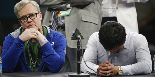 Trainer Freddie Roach, left, listens as Manny Pacquiao answers reporter questions during a press conference following his welterweight title fight on Saturday, May 2, 2015 in Las Vegas. Floyd Mayweather defeated Pacquiao in a unanimous decision. (AP Photo/John Locher)