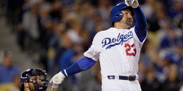 Los Angeles Dodgers' Adrian Gonzalez watches his solo home run in front of San Diego Padres catcher Derek Norris during the fifth inning of a baseball game in Los Angeles, Wednesday, April 8, 2015. It was Gonzalez's third homer of the night. (AP Photo/Alex Gallardo)