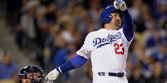 Los Angeles Dodgers' Adrian Gonzalez watches his solo home run in front of San Diego Padres catcher Derek Norris during the fifth inning of a baseball game in Los Angeles, Wednesday, April 8, 2015. It was Gonzalez's third homer of the night. (AP Photo/Alex Gallardo)