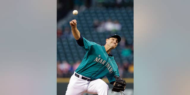 Seattle Mariners starting pitcher Chris Young throws against the San Diego Padres in the fifth inning in a baseball game Monday, June 16, 2014, in Seattle. (AP Photo/Elaine Thompson)