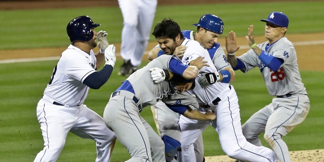 April 11, 2013: San Diego Padres' Carlos Quentin, center, and teammates battle the Los Angeles Dodgers after Quentin was hit by a pitch thrown by Angeles Dodgers pitcher Zack Greinke in the sixth inning of baseball game in San Diego.