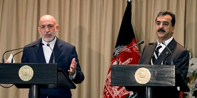 Afghan President Hamid Karzai, left, speaks, with Pakistani Prime Minister Yousuf Raza Gilani on the right, during a joint press conference in Islamabad, Pakistan.