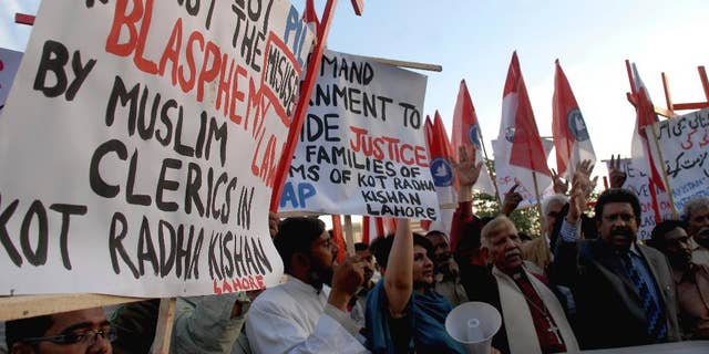 Pakistani human rights activists condemn the killing of a Christian couple during a demonstration in Islamabad, Pakistan, Wednesday, Nov. 5, 2014. Police in Pakistan said Tuesday a Muslim mob has beaten to death a Christian couple and burned their bodies in a brick kiln where they worked over them allegedly desecrating the Quran. (AP Photo/B.K. Bangash)