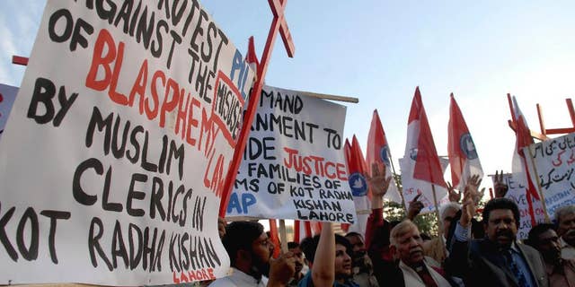 Pakistani human rights activists condemn the killing of a Christian couple during a demonstration in Islamabad, Pakistan, Wednesday, Nov. 5, 2014. Police in Pakistan said Tuesday a Muslim mob has beaten to death a Christian couple and burned their bodies in a brick kiln where they worked over them allegedly desecrating the Quran. (AP Photo/B.K. Bangash)