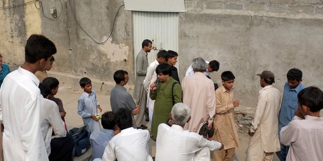 Aug. 20- People gathered outside the locked house of a Christian girl in suburbs of Islamabad, Pakistan. Pakistani authorities arrested a Christian girl and are investigating whether she violated the country's strict blasphemy laws.