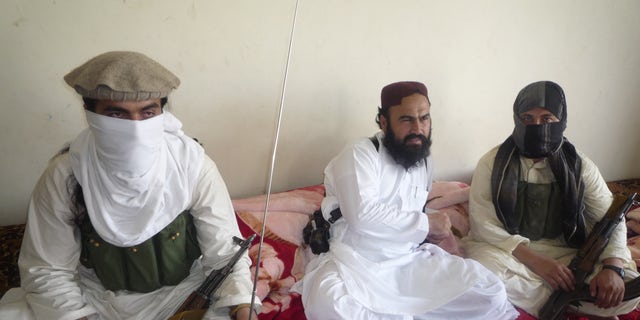 July 28, 2011: Taliban No 2 commander Waliur Rehman, centre , flanked by militants, talks to the Associated Press in Shawal area of South Waziristan along the Afghanistan border in Pakistan. The Pakistani Taliban has custody of two kidnapped Swiss tourists, but is willing to free them if the U.S. releases a female Pakistani scientist convicted of trying to kill Americans, Rehman told The Associated Press. The couple's identity has not been disclosed.