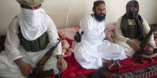 July 28, 2011: Taliban No 2 commander Waliur Rehman, centre , flanked by militants, talks to the Associated Press in Shawal area of South Waziristan along the Afghanistan border in Pakistan. The Pakistani Taliban has custody of two kidnapped Swiss tourists, but is willing to free them if the U.S. releases a female Pakistani scientist convicted of trying to kill Americans, Rehman told The Associated Press. The couple's identity has not been disclosed.