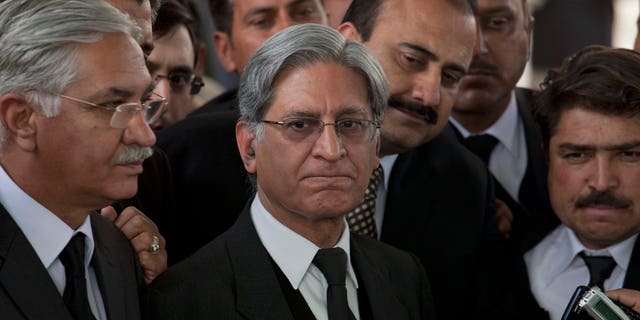 Feb. 2, 2012: Aitzaz Ahsan, center, lawyer of Pakistan's Prime Minister Yusuf Raza Gilani listens to reporters outside the Supreme Court in Islamabad, Pakistan.