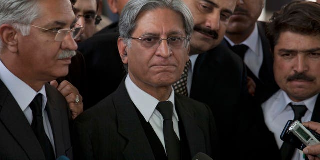 Feb. 2, 2012: Aitzaz Ahsan, center, lawyer of Pakistan's Prime Minister Yusuf Raza Gilani listens to reporters outside the Supreme Court in Islamabad, Pakistan.