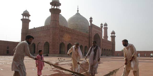 Preparations are in progress for the upcoming Ramadan at the 17th century Badshahi mosque in Lahore, Pakistan, Wednesday, June 17, 2015. Muslims throughout the world mark the month of Ramadan, the holiest month in the Islamic calendar, with dawn to dusk fasting. (AP Photo/K.M. Chaudary)