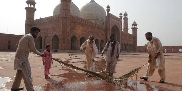 Preparations are in progress for the upcoming Ramadan at the 17th century Badshahi mosque in Lahore, Pakistan, Wednesday, June 17, 2015. Muslims throughout the world mark the month of Ramadan, the holiest month in the Islamic calendar, with dawn to dusk fasting. (AP Photo/K.M. Chaudary)
