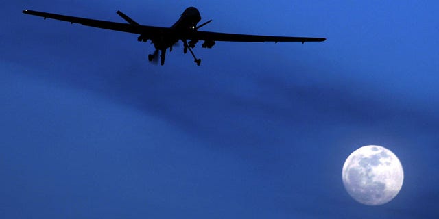 FILE - In this Jan. 31, 2010 file photo, an unmanned U.S. Predator drone flies over Kandahar Air Field, southern Afghanistan, on a moon-lit night. (AP Photo)