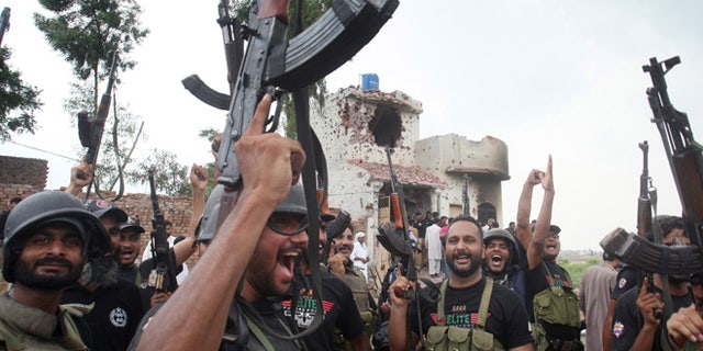 July 17, 2014: Pakistani police commandos celebrate a successful operation against terrorists in Lahore, Pakistan. (AP)