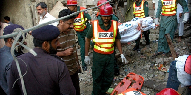 Oct. 25, 2010: In this photo released by China's Xinhua news agency, people gather at the blast site in Pak Pattan, a city in Pakistan's Punjab province, early Monday morning.