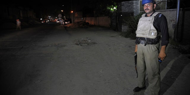 June 25, 2014: A Pakistani police officer stands guard near Peshawar airport which is cordon off, Wednesday, June 25, 2014 in Pakistan. (AP Photo/Mohammad Sajjad)