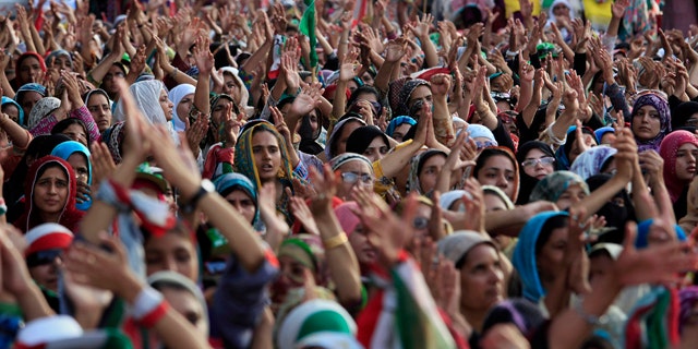 August 17, 2014: Supporters of Pakistan's fiery anti-government cleric Tahir-ul-Qadri praise their leader at a rally in Islamabad. Pakistan's cricketer-turned-politician Imran Khan and Qadri led massive rallies in Pakistan's capital, demanding Prime Minister Nawaz Sharif step down over alleged fraud in last years election in front of thousands of protesters. (AP Photo/Anjum Naveed)