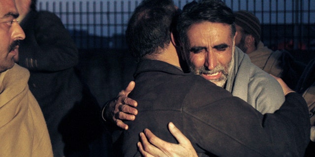 Jan. 1, 2013: A father of an aid worker, who was killed by gunmen, mourns the death of his daughter at a hospital in Swabi, Pakistan.