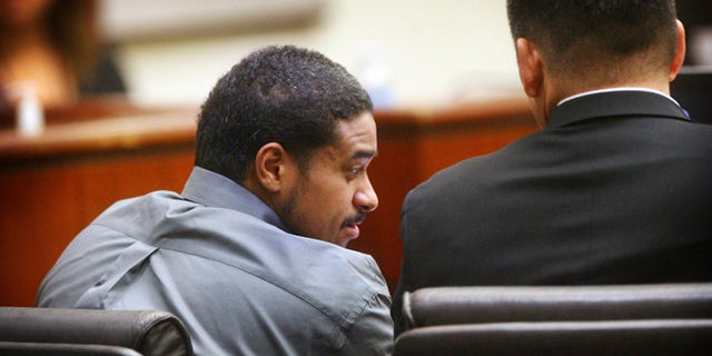 John Hernandez Felix confers with his attorney Michael Rowlands on Thursday, Oct. 13, 2016 in Indio, Calif.