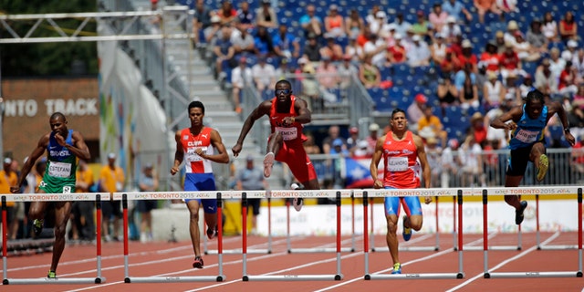 USA's Kerron Clement jumps over a hurdle and wins during a men's 400m hurdles semifinal race at the Pan Am Games in Toronto, Wednesday, July 22, 2015. (AP Photo/Mark Humphrey)