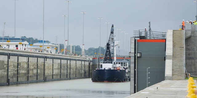 A Panama Canal Authority crane ship Oceanus, navigates the Cocoli locks during a test of the newly expanded Panama Canal locks on Pacific side, in Cocoli, Panama, Monday, June 20, 2016. The canal's expansion project will be officially inaugurated on June 26. (AP Photo/Arnulfo Franco)
