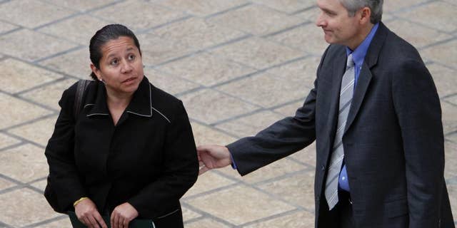 FILE - In this Nov. 22, 2010 file photo, Panama's Deputy Foreign Minister Alvaro Aleman, right, accompanies Maria del Pilar Hurtado, former head of Colombia's domestic intelligence agency, as she leaves the foreign ministry building, in Panama City. After several years on the run the ex-spy chief surrendered to authorities in Panama, Friday, Jan. 30, 2015, to face charges of spying on opponents of Colombia's former President Alvaro Uribe. She’s now being held at the chief prosecutor’s office in Colombia awaiting arraignment. (AP Photo/Arnulfo Franco, File)