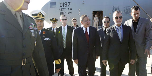 December 17, 2011: U.S. Sec. of Defense Leon Panetta walks across the tarmac during his arrival in Tripoli, Libya.