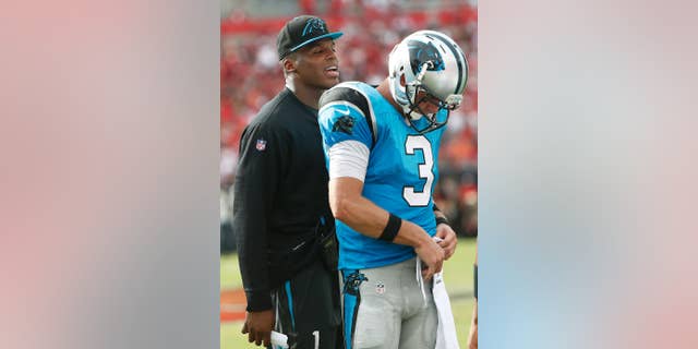 FILE - In this Sept. 7, 2014, file photo, Carolina Panthers quarterback Cam Newton, left, talks to quarterback Derek Anderson (3) during the second quarter of an NFL football in Tampa, Fla. Anderson proved he's a solid backup quarterback to have, throwing two TDs in Carolina's win against Tampa Bay. Now the question is if Anderson heads back to the bench or will start next Sunday's home opener against Detroit. (AP Photo/Brian Blanco, File)