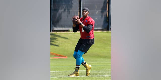 FILE - In this June 17, 2014 file photo, Carolina Panthers quarterback Cam Newton throws a pass during NFL football practice in Charlotte, N.C. Panthers coach Ron Rivera is expected to give an update on Newton's ankle on Thursday, July 24, 2014,one day before the team takes the field for the start of training camp. (AP Photo/Nell Redmond, File)