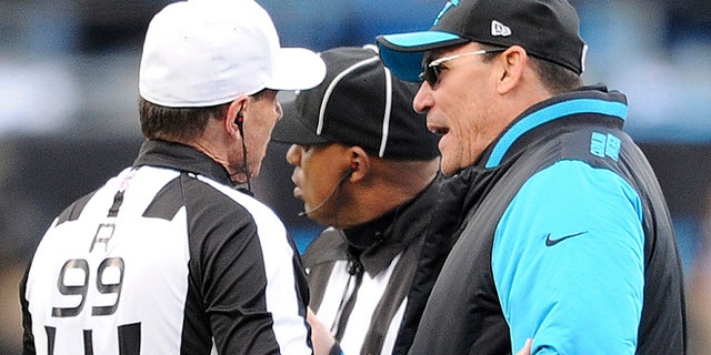 Carolina Panthers head coach Ron Rivera speaks to referee Tony Corrente (99) during the second half of an NFL divisional playoff football game against the Seattle Seahawks, Sunday, Jan. 17, 2016, in Charlotte, N.C. (AP Photo/Mike McCarn)