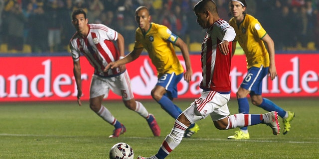 Paraguay's Derlis Gonzélez shoots from the penalty spot to scorer his sides first goal during a Copa America quarterfinal soccer match against Brazil at the Ester Roa Rebolledo Stadium in Concepción, Chile, Saturday, June 27, 2015. (AP Photo/Silvia Izquierdo)
