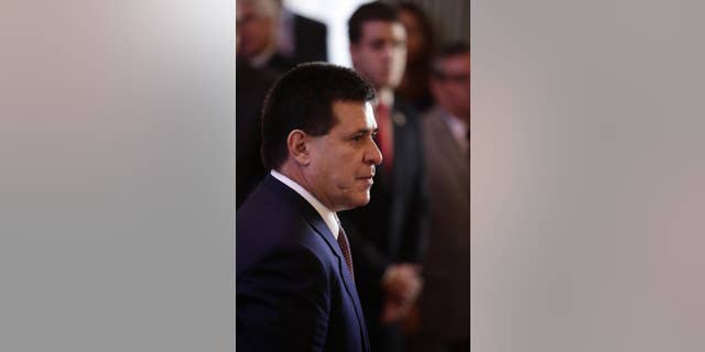 FILE - In this Jan. 5, 2015 file photo, Paraguay's President Horacio Cartes attends an event at the Lopez Presidential Palace in Asuncion, Paraguay. During a Tuesday, Jan. 13, 2015, visit to a village where new homes are being constructed, Cartes, in a heated speech, urged his colleagues to "stop stealing" the people's money. Among the attendees were regional lawmakers, governors, departmental councilors and ministers. (AP Photo/Jorge Saenz, File)