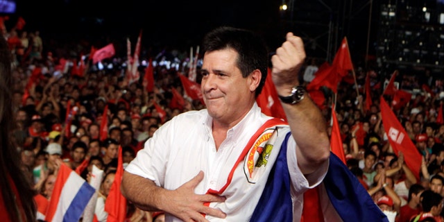 Horacio Cartes, presidential candidate of Colorado Party, dances during a campaign rally in Capiata, Paraguay, Friday, April 5, 2013. Paraguay will hold presidential elections on April 21. (AP Photo/Jorge Saenz)
