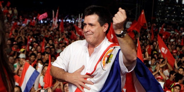 Horacio Cartes, presidential candidate of Colorado Party, dances during a campaign rally in Capiata, Paraguay, Friday, April 5, 2013. Paraguay will hold presidential elections on April 21. (AP Photo/Jorge Saenz)