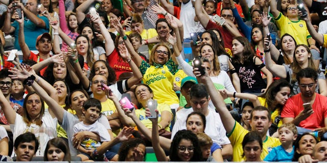 Spectators dance and cheer during the women's sitting volleyball preliminary game between Iran and the USA at the 2016 Paralympic Games in Rio de Janeiro, Brazil, Saturday, Sept. 10, 2016. Total ticket sales now sit at 1,863,000, the second-highest Paralympic Games total ever, behind London. (Jenn Finch/University of Georgia via AP)