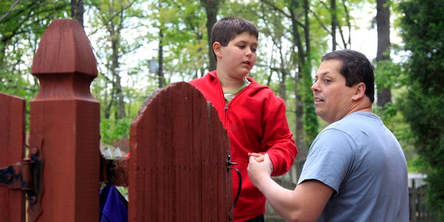 April 25, 2012: Stuart Chaifetz stands with his son Akian Chaifetz, 10, at their home in Cherry Hill, N.J.