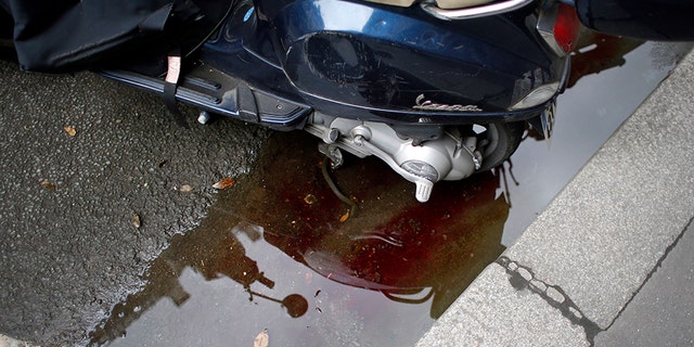 A blood trail of the assailant of a knife attack Saturday that left at least two dead including the assailant is seen in central Paris, Sunday.